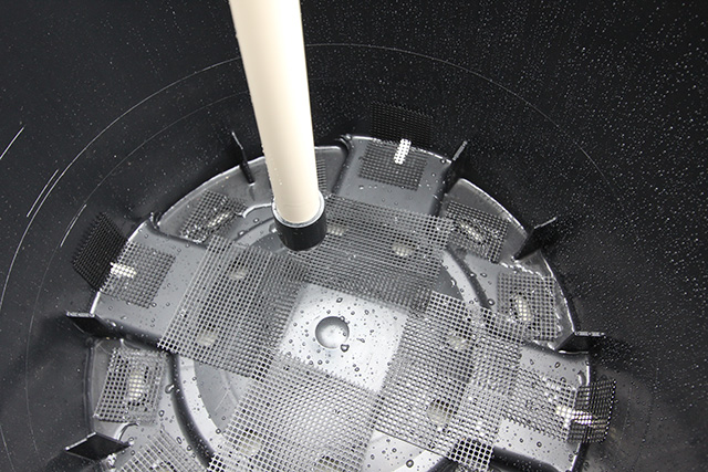 ポットの底にあるいくつかの穴に小さく切った防虫網があてられている